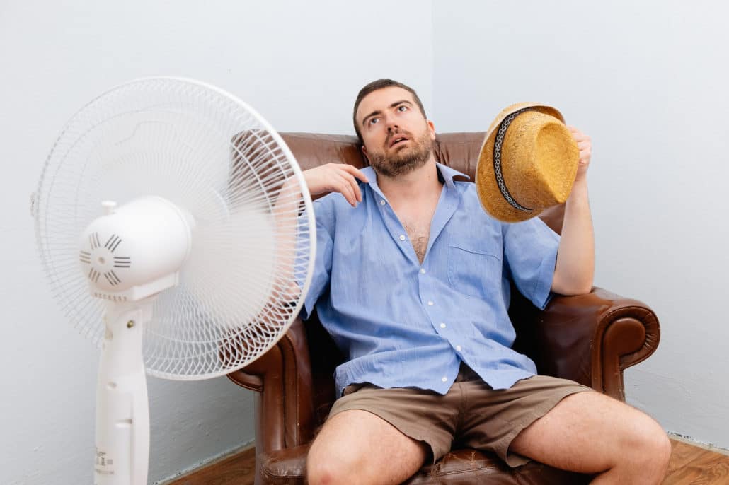 Man sitting in front of a fan