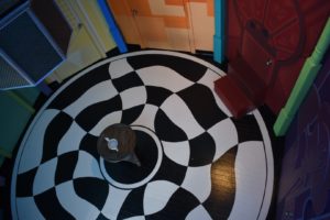 Room with a checker board floor and table in center
