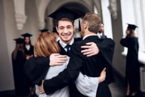 Parents hugging son at graduation