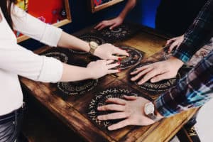 Group of people with hands on puzzle