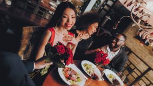 A woman accepting roses at nice dinner